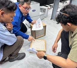Technicians reviewing a Work Instruction sheet during Installation & Commissioning training