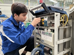 DSI technician repairing the internal components of a Pulse Laser Welding machine