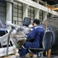 Technician performing pulsed laser beam welding repair on a steam turbine