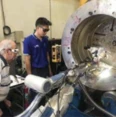 Technician pulsed laser beam welding a shock absorber housing