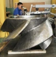 Technician pulse laser welding a large duplex steel component