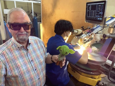 Prof. Dr.-Ing. G. Kuscher observing a pulse laser welding demonstration