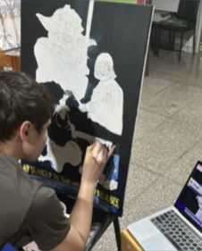 Christian Banpao painting the Yoda and Darth Vader artwork