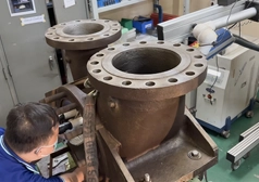 DSI technician repairing a grey cast iron valve casing