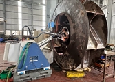DSI technician refurbishing a large cylindrical chamber