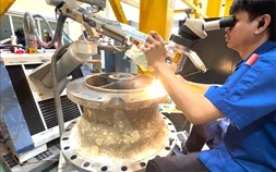 DSI technician inspecting a refurbished crankshaft